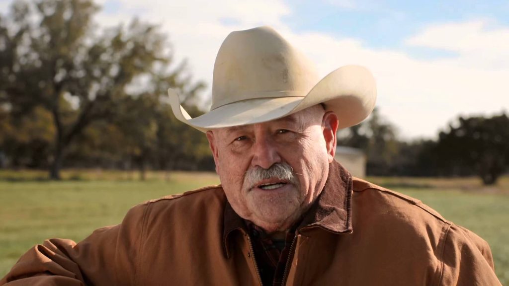 Barry Corbin, posing outdoors wearing a cowboy hat